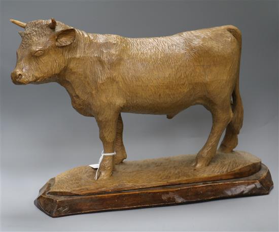 Lys. A carved wood figure of a cow height 36cm approx.